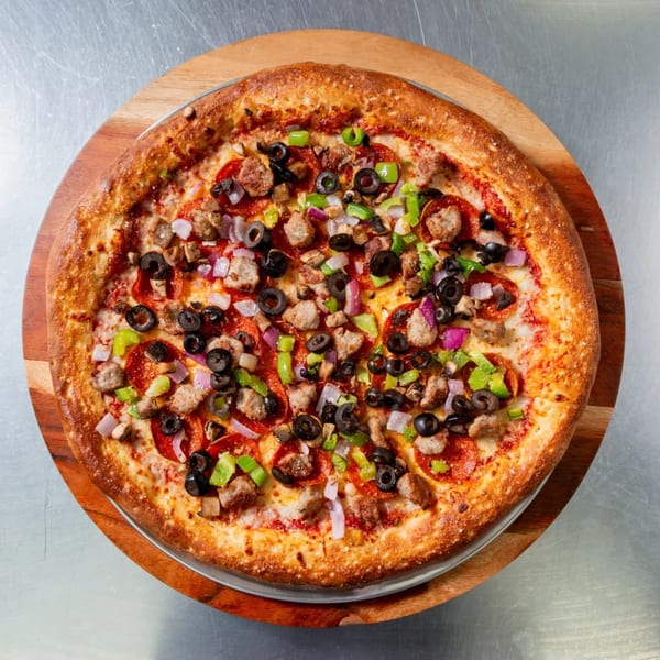 A New York Vinny's Pizza with pepperoni, sausage, olives, green peppers, and red onions.